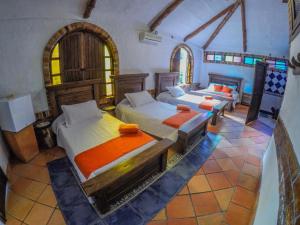 Posteľ alebo postele v izbe v ubytovaní Hotel Hacienda Gualanday