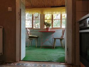 a dining room with a table and two chairs at Ferienhaus Caselow 23A in Bergholz