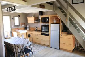 a kitchen with a table and a kitchen with a staircase at Chalet CAL CAPOU in Bolquere Pyrenees 2000