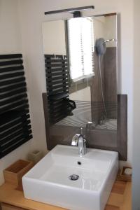 a bathroom with a sink and a mirror and a tub at Chalet CAL CAPOU in Bolquere Pyrenees 2000