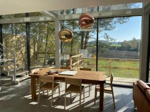 a dining room with a table and chairs and a large window at high-Q in Kowalewo