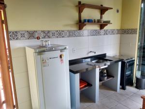 A cozinha ou kitchenette de Condominio Aldeia da Praia