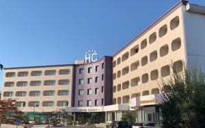 a hotel building with a sign on top of it at Hotel & Residence Castelli in Montecchio Maggiore