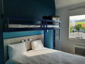 a bedroom with two bunk beds and a window at ibis budget Bar le Duc in Bar-le-Duc +37 photos