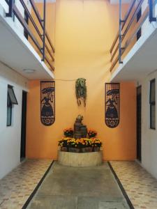 a hallway of a building with a plant on the wall at Hotel Villa Hermosa in Oaxaca City