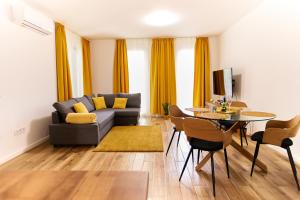 a living room with a couch and a table at STARLIGHT BRONZE Szeged- Exclusive in Szeged