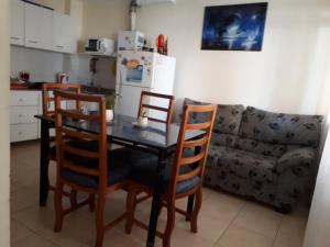 a kitchen with a table and chairs and a couch at mi depto en cba in Córdoba