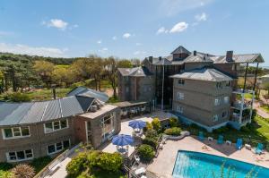 an aerial view of a resort with a pool and a building at Victoria Village in Carilo