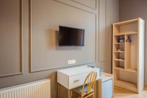 a room with a desk and a tv on a wall at Galaktioni 22 in Tbilisi City