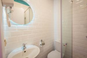 a bathroom with a sink and a toilet and a mirror at Galaktioni 22 in Tbilisi City