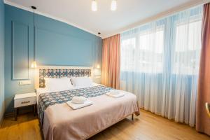 a hotel room with a bed with two towels on it at Galaktioni 22 in Tbilisi City