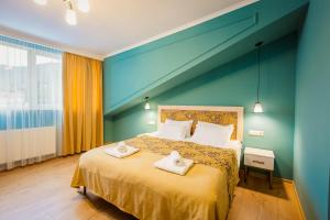 a bedroom with a bed with two towels on it at Galaktioni 22 in Tbilisi City +33 photos