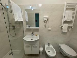a bathroom with a sink and a toilet and a shower at Sole in Gattinara