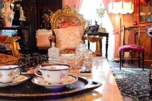 a room with a table with tea cups and a chair at Charlemont House Exclusive Hire Perfect for Groups of 8 to 23 persons in Moy