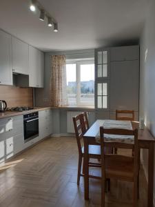 a kitchen with a table and chairs and a window at Best Apartment Truskavets in Truskavets