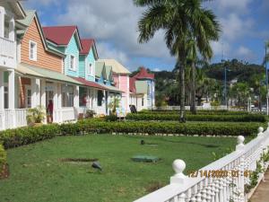 a group of houses with birds in a yard at Pelicano Tropical Paraiso Samana in Santa Bárbara de Samaná