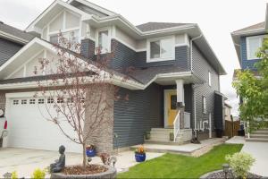 a house with blue siding at Modern Executive Suite I Complimentary Netflix & Parking! in Edmonton