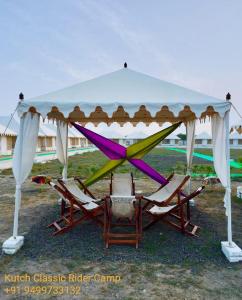 a group of chairs under a gazebo at Kutch Classic Resort Camp in Dhordo