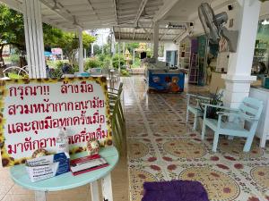 a room with chairs and a table with books on it at ฟ้าประทานบูติกรีสอร์ท in Prachuap Khiri Khan