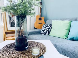 a vase with flowers on a table in a living room at Zhe·Yi Boutique Guesthouse in Beijing
