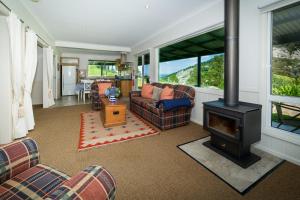 
a living room filled with furniture and a fire place at The Bryn at Tilba in Central Tilba
