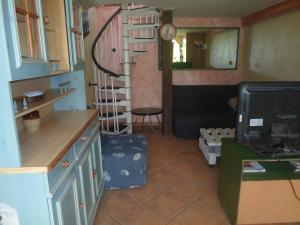 a kitchen with a spiral staircase in a room at coquet f2 avec petite terrasse in Canet-en-Roussillon