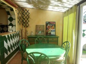 a table and chairs in a room with a table and a window at coquet f2 avec petite terrasse in Canet-en-Roussillon