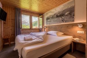 Säng eller sängar i ett rum på Hotel Walser