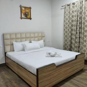 a bedroom with a large bed with white towels on it at Kivi's kozy 2bhk luxurious apartment Goa by leela homes in Arpora