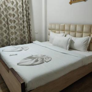 a bed with a dress on top of it at Kivi's kozy 2bhk luxurious apartment Goa by leela homes in Arpora