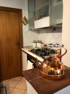 a tea kettle sitting on top of a stove in a kitchen at Casa nel borgo in Piglio