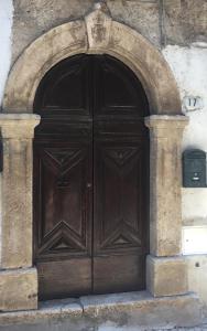 a large wooden door in a stone building at Casa nel borgo in Piglio