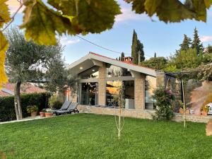 a house with a lawn in front of it at Studio Solare in Portorož