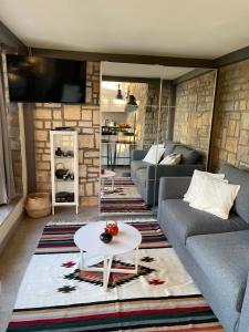 a living room with a couch and a table at Studio Solare in Portorož