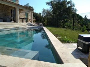 a swimming pool in front of a house at Studio Faillant Lorgues spa privatif avec superbe piscine in Lorgues +11 photos