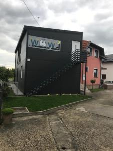 a building with aww sign on the side of it at WooW Apartments in Velika Gorica