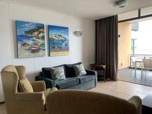 a living room with a couch and two chairs at 307 Point Bay in Durban