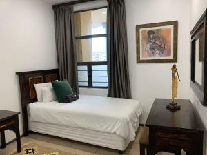 a bedroom with a bed and a window at 307 Point Bay in Durban +32 photos