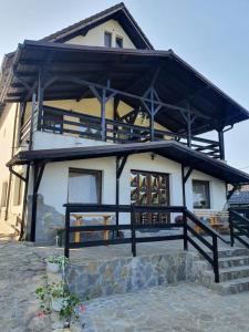 a large house with a black roof at Casa Hoinarilor Wanderers House in Bran