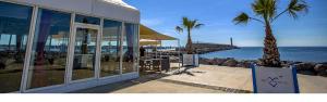 a building with palm trees in front of the ocean at APPARTEMENT 6 PERSONNES in Port-la-Nouvelle +17 photos