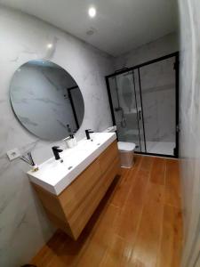a bathroom with a sink and a mirror at UIM Mediterraneo PB Columbretes 12 Wifi in Puerto de Sagunto +10 photos