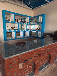a brick counter in a room with blue shelves at Al Baeirat Hotel in Luxor
