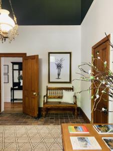 a living room filled with furniture and a wooden floor at de Wingerd B & B in Graaff-Reinet