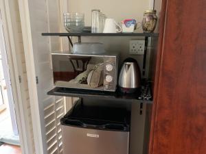 a microwave on a shelf in a kitchen at Springside House in Hillcrest