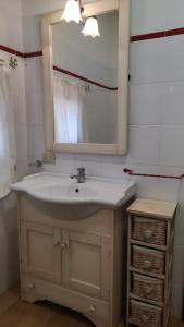 a bathroom with a sink and a mirror at Residence Spiaggia Bianca in Golfo Aranci