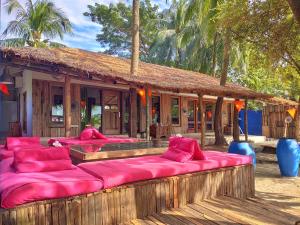 a group of pink pillows sitting in front of a building at Mermaid Beach Resort in Dhoāpālong