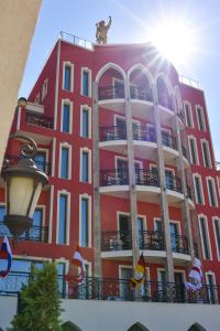 a red building with a dog on top of it at Alchemist Residence Von Goldenburg in Plovdiv