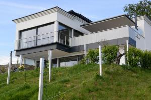 a white house on top of a hill at Nikolaier Weinblick - Chalet Sauvignon Blanc in Sankt Nikolai ob Draßling