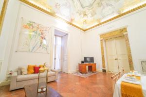a living room with a couch and a ceiling at Casa Napoletana - Culture Apartment in Naples