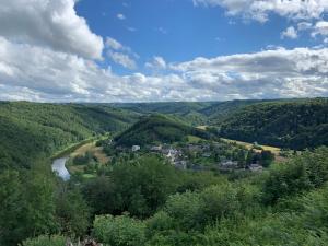 a view of a valley with a river and a town at Maison de Rochehaut in Rochehaut